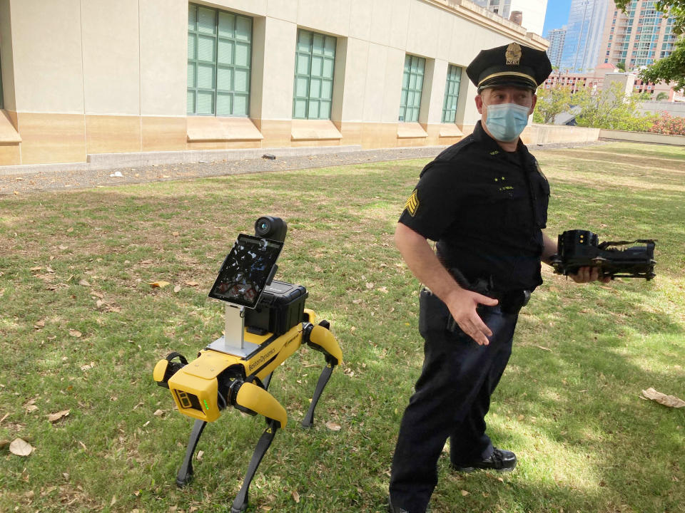 Honolulu Police Acting Lt. Joseph O’Neal demonstrates a robotic dog in Honolulu, Friday May 14, 2021. Police officials experimenting with the four-legged machines say they’re just another tool, like drones or simpler wheeled robots, to keep emergency responders out of harm’s way. (AP Photo/Jennifer Sinco Kelleher)