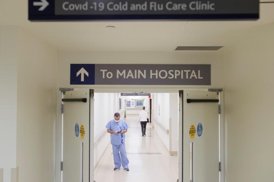 A healthcare worker is pictured near the emergency department at Markham Stouffville Hospital, in Markham, Ont., on Dec. 1, 2022.