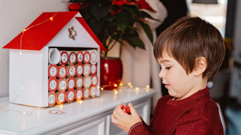 little boy with chocolate advent calendar