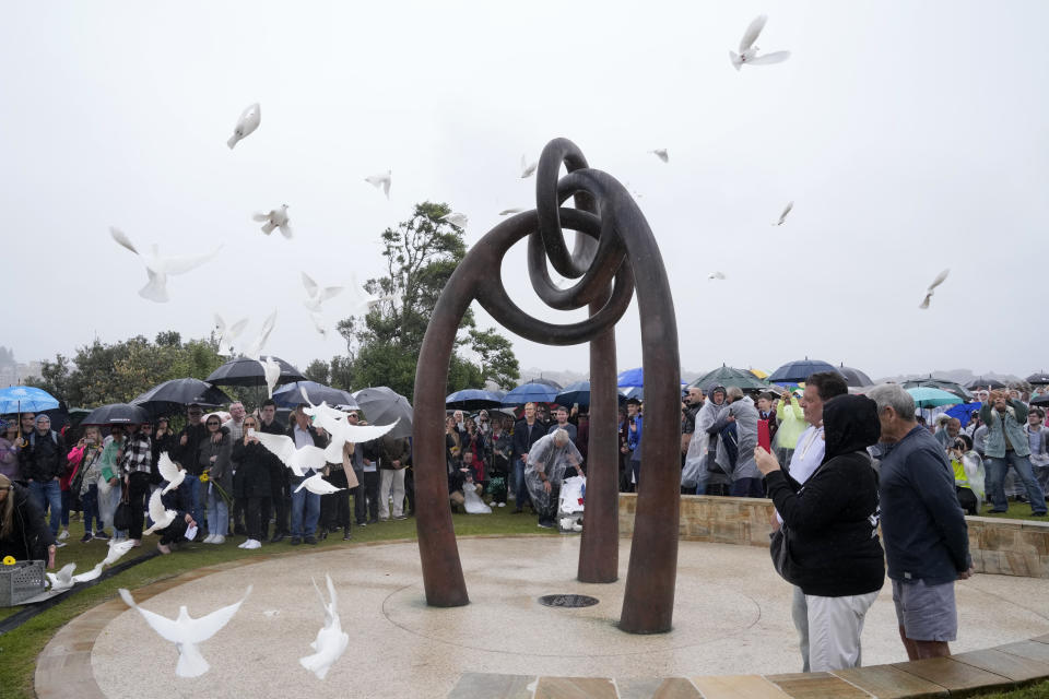 Doves are released during a memorial ceremony in Sydney, Australia, Wednesday, Oct. 12, 2022, honoring the victims of the 2002 Bali bombing that killed 202 people, mostly foreign tourists, including 88 Australians, and seven Americans. (AP Photo/Rick Rycroft)