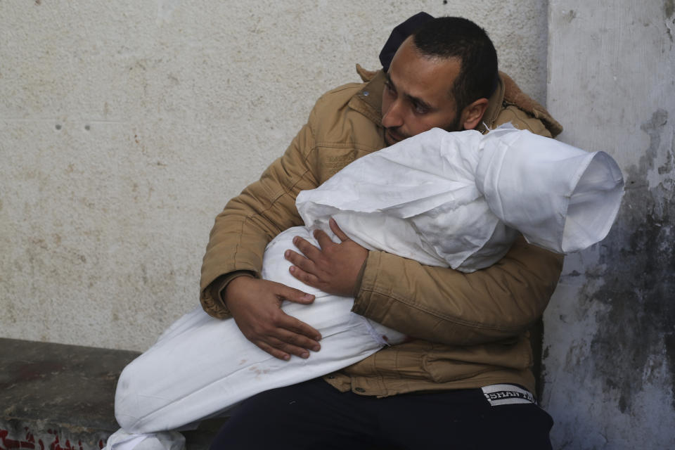 A Palestinian holds his child killed( in the Israeli bombard, ent of the Gaza Strip, at a morgue in Rafah, Wednesday, Feb. 21, 2024. AP Photo/Hatem Ali)
