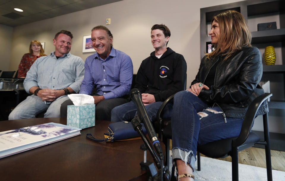 Brendan Bialy, third from left, joins mother Dena Martin, right, father Brad Bialy, far left, and attorney Mark Bryant to speak about his role in stopping the attack at the STEM School Highlands Ranch during a news conference Wednesday, May 8, 2019, in Englewood, Colo. Eighteen-year-old Bialy said he, Kendrick Castillo and a third student tried to stop the gunman by charging at him during Tuesday's attack at the STEM School Highlands Ranch. (AP Photo/David Zalubowski)