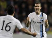 Manchester City's Edin Dzeko (R) celebrates with team mate Sergio Aguero after scoring a goal against Viktoria Plzen during their Champions League group D soccer match at the Doosan Arena in Prague, Czech Republic September 17, 2013. REUTERS/David Cerny (CZECH REPUBLIC - Tags: SPORT SOCCER)