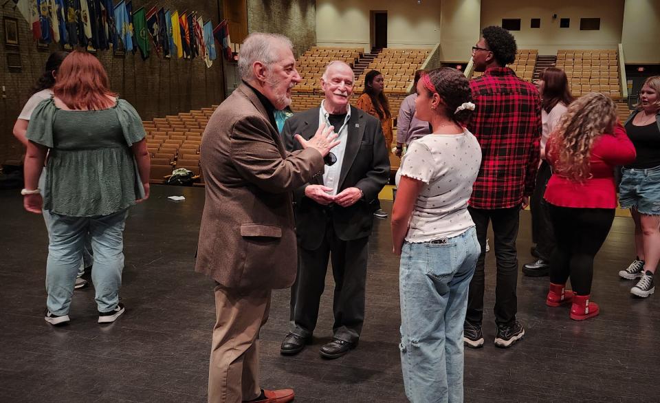 Armand Marchand (foreground, left) and George Charbonneau (foreground, center) chat with a New Bedford High Drama Club member as the two former longtime New Bedford High School Drama Club directors and founding leaders of the New Bedford Festival Theatre stopped in for a visit Monday night.