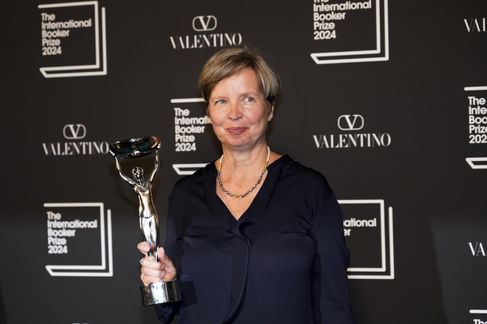 Jenny Erpenbeck, author of 'Kairos', holds the trophy after winning the International Booker Prize, in London, Tuesday, May 21, 2024. (AP Photo/Alberto Pezzali)