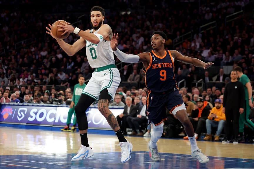 Boston Celtics forward Jayson Tatum (0) controls the ball against New York Knicks guard RJ Barrett (9) during the first quarter at Madison Square Garden.