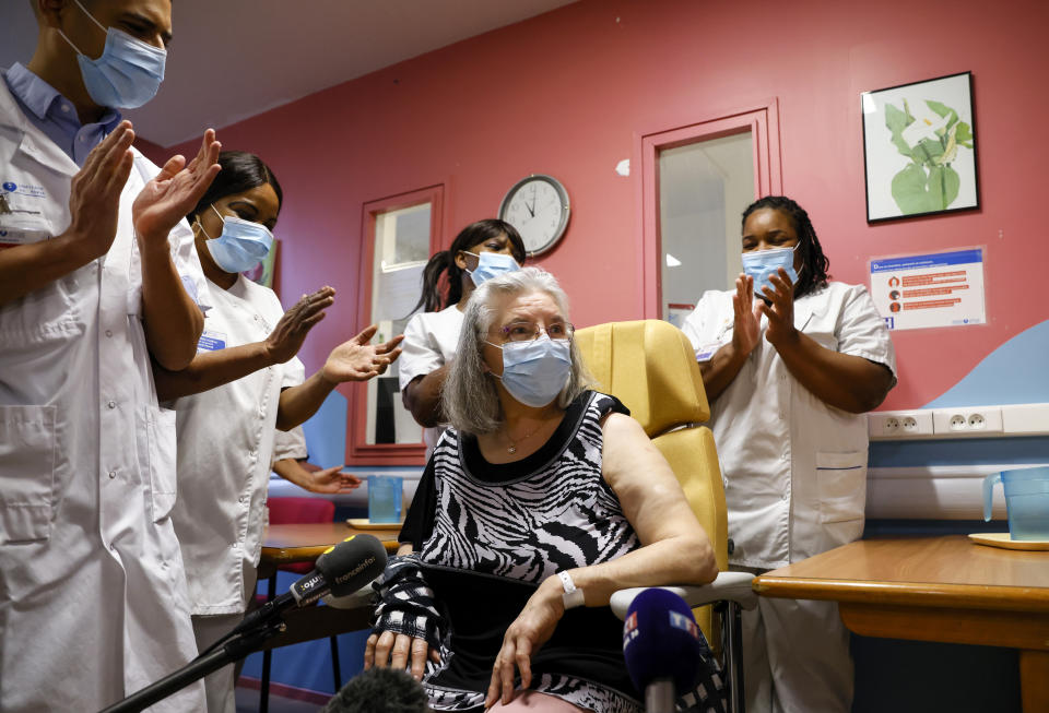 Medical staff members applause after Mauricette, a French 78-year-old woman, received the first COVID-19 in France at the Rene-Muret hospital in Servan near Paris, Sunday Dec. 27, 2020. France is starting its first vaccinations Sunday against the coronavirus at a nursing home northeast of Paris, in one of France's poorest regions. (Thomas Samson/Pool Photo via AP)