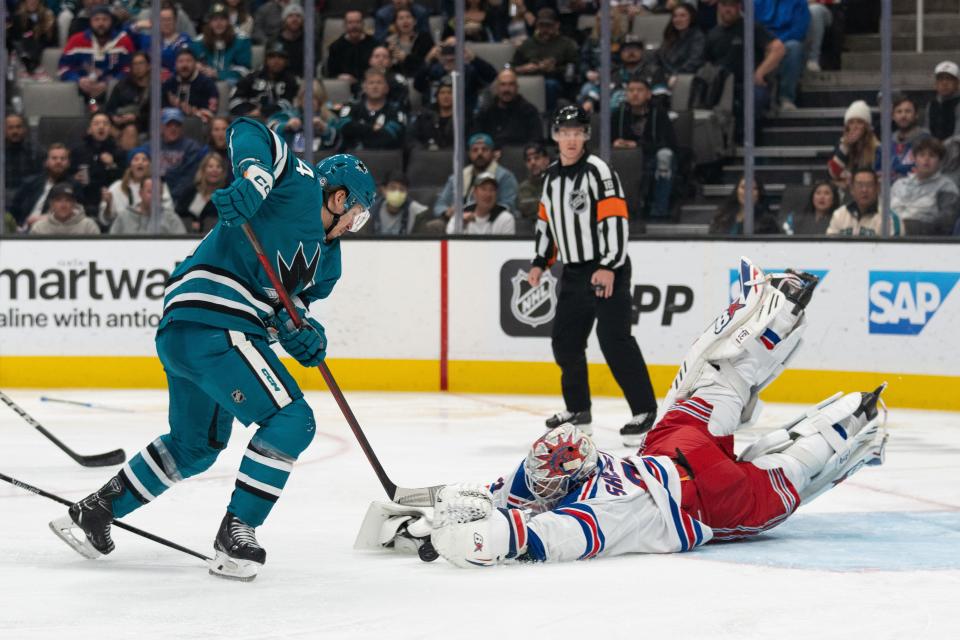 Jan 23, 2024; San Jose, California, USA; New York Rangers goaltender Igor Shesterkin (31) dives towards the puck during the second period against San Jose Sharks left wing Alexander Barabanov (94) at SAP Center at San Jose.