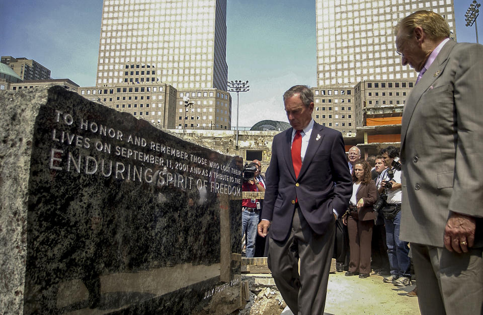 File-This photo from Sunday, July, 4, 2004, shows developer Larry Silverstein, right, and New York Mayor Michael Bloomberg at the unveiling of a 9-foot-by-4-foot granite cornerstone, after it was lifted into its resting spot at the World Trade Center site in New York. In 2006, Bloomberg joined the 9/11 memorial foundation board and became chairman to boost fundraising, giving at least $15 million of his own fortune. (AP Photo/Dean Cox, File)