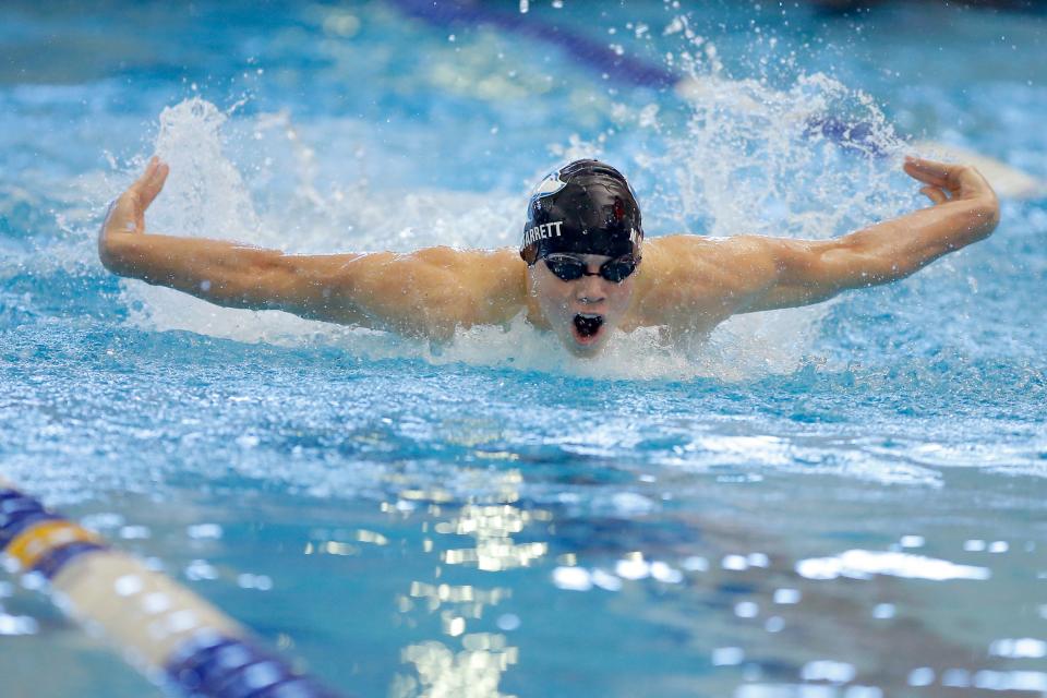 Edmond North's Jack Starrett competes in the 100-yard butterfly during the Class 6A state meet at Edmond Schools Aquatic Center on Feb. 19, 2022.