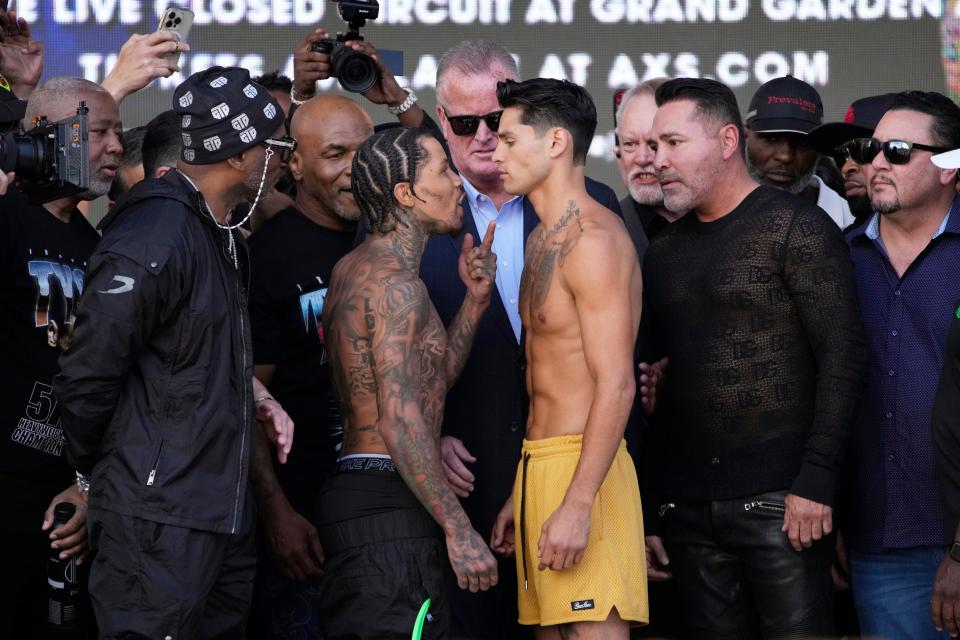 Gervonta Davis, center left, and Ryan Garcia face off during a weigh-in Friday, April 21, 2023, in Las Vegas. The two are scheduled to fight in a catchweight boxing bout in Las Vegas on Saturday. (AP Photo/John Locher)