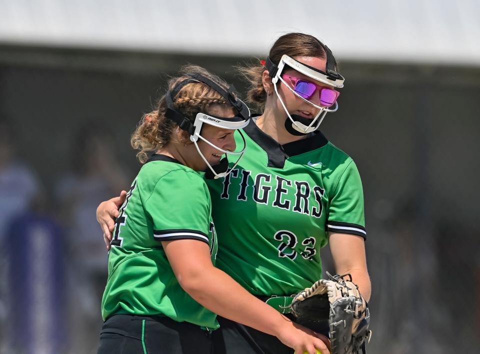 Yorktown softball's Jenna Sylvester (right) hugs Caitlin LaFerney in the IHSAA Class 3A Delta sectional championship on Saturday, May 27, 2023.