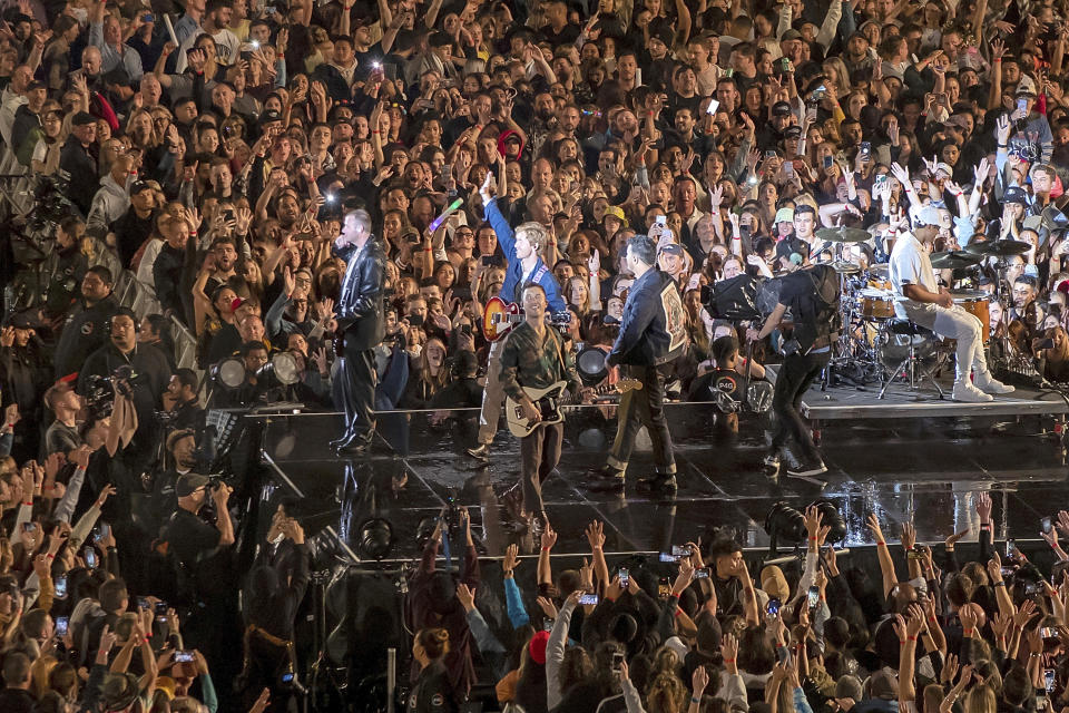 New Zealand band Six60 perform at Eden Park in Auckland, New Zealand, Saturday, April 24, 2021. Six60 is being billed as the biggest live act in the world since the coronavirus pandemic struck after New Zealand stamped out the spread of the virus, allowing life to return to normal. On Saturday, the band played a remarkable finale to their latest tour, performing in front of 50,000 people at the first-ever concert at Auckland's Eden Park.(AP Photo/David Rowland)