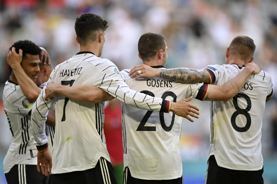 Germany's Robin Gosens celebrates with Kai Havertz and Toni Kroos, right, after scoring his side's fourth goal during the Euro 2020 soccer championship group F match between Portugal and Germany at the Football Arena stadium in Munich, Germany, Saturday, June 19, 2021. (Philipp Guelland/Pool via AP)