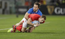 Wales' Jonathan Davies, right, is tacked by Italy's Jayden Hayward during the Six Nations rugby union international between Italy and Wales, at Rome's Olympic Stadium, Saturday, Feb. 9, 2019. (AP Photo/Andrew Medichini)