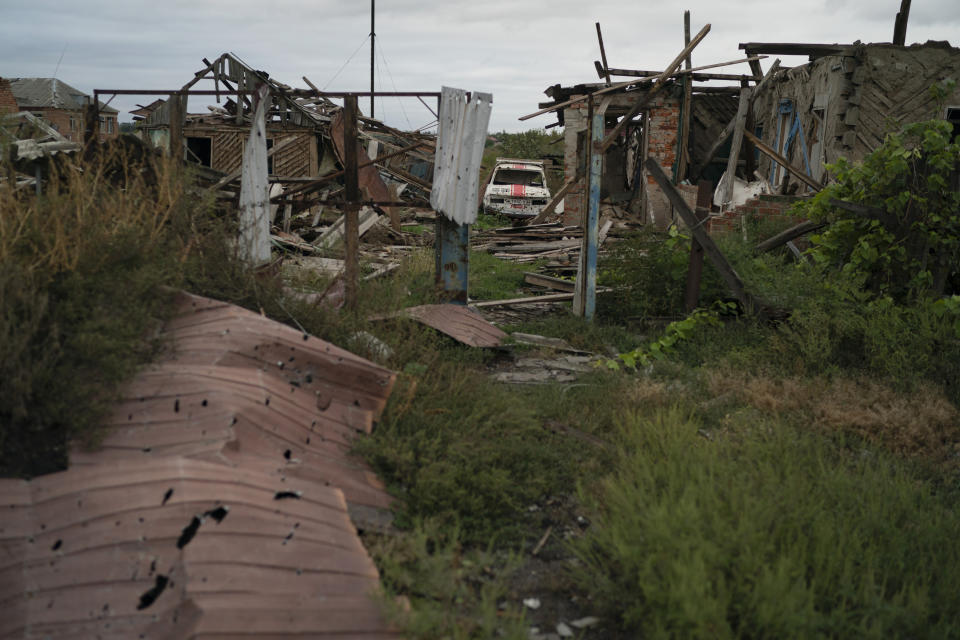 A destroyed car is seen next to heavily damaged houses in the freed village of Hrakove, Ukraine, Tuesday, Sept. 13, 2022. Russian troops occupied this small village southeast of Ukraine’s second largest city of Kharkiv for six months before suddenly abandoning it around Sept. 9 as Ukrainian forces advanced in a lightning-swift counteroffensive that swept southward. (AP Photo/Leo Correa)