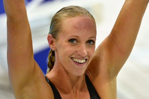 US swimmer Dana Vollmer celebrates after breaking the world record in the women's 100m butterfly final swimming event at the London 2012 Olympic Games in London