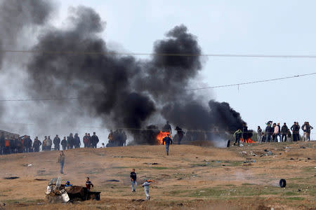 FILE PHOTO - Palestinian protestors are seen on the Gaza side of the Israel Gaza border during a demonstration, December 15, 2017. REUTERS/Amir Cohen