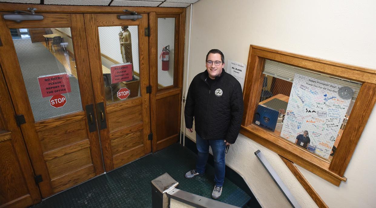 Kyle Kubik, Monroe Catholic Elementary Schools principal, is shown in the entryway of the St. John campus. MCES will no longer use the St. John building for classes after this school year.