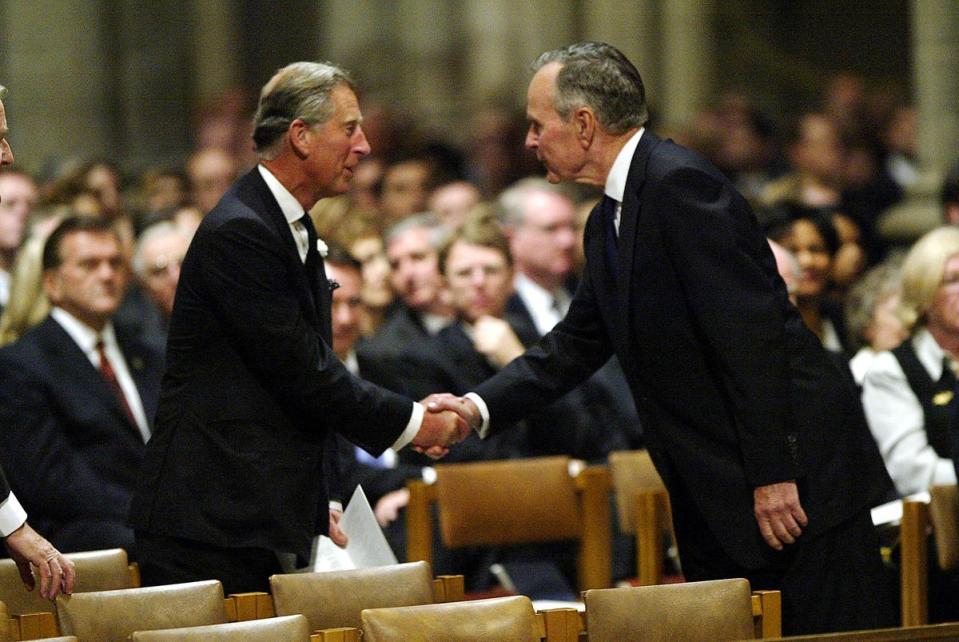 Former US president George HW Bush greets Prince Charles at the funeral of Ronald Reagan in Washington, DC in June 2004 (AFP via Getty Images)