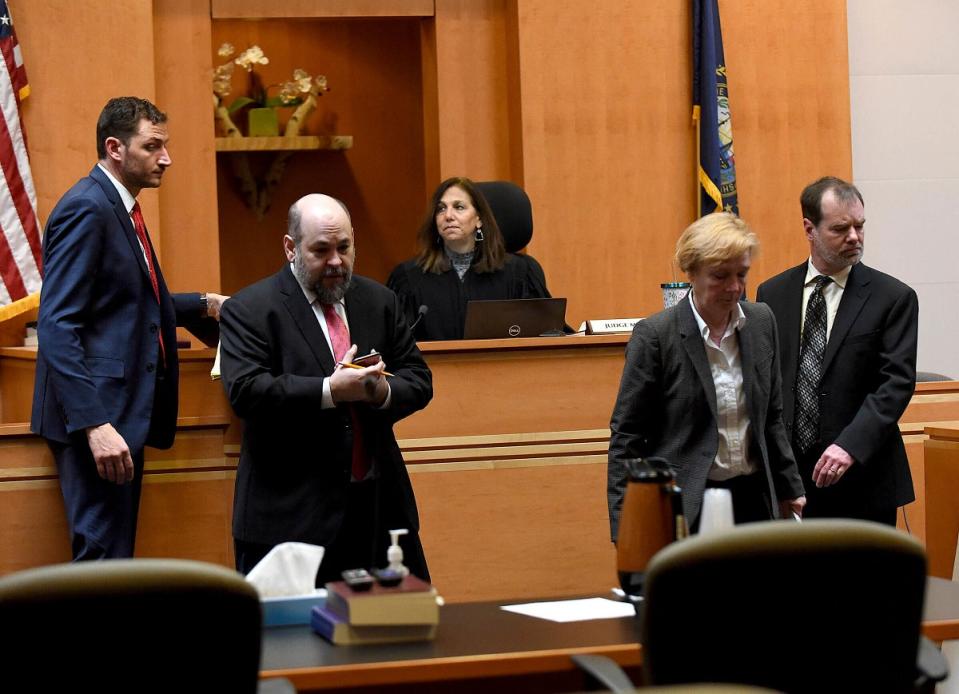 Superior Court Justice Amy Messer, background, watches as Assistant New Hampshire Attorney General Christopher Knowles, from left, Senior Assistant New Hampshire Attorney General Benjamin Agati and defence lawyers Caroline Smith and James Brooks walks back to their posts following a bench meeting (AP)
