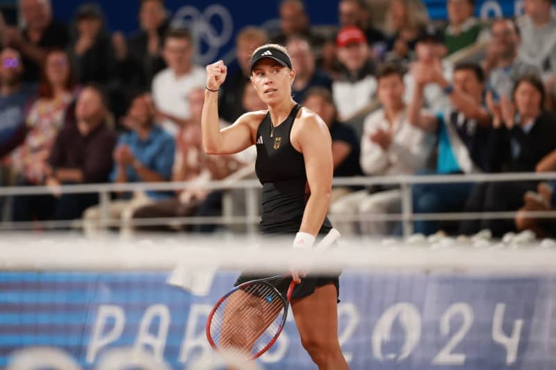 German tennis player Angelique Kerber celebrates defeating Japanese Naomi Osaka during their women's singles 1st round tennis match at Roland-Garros on the first day of the Paris 2024 Olympic Games. Jan Woitas/dpa