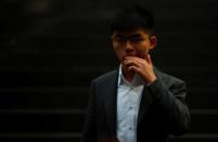 Hong Kong's pro-democracy activist Joshua Wong reacts after a news conference in Berlin