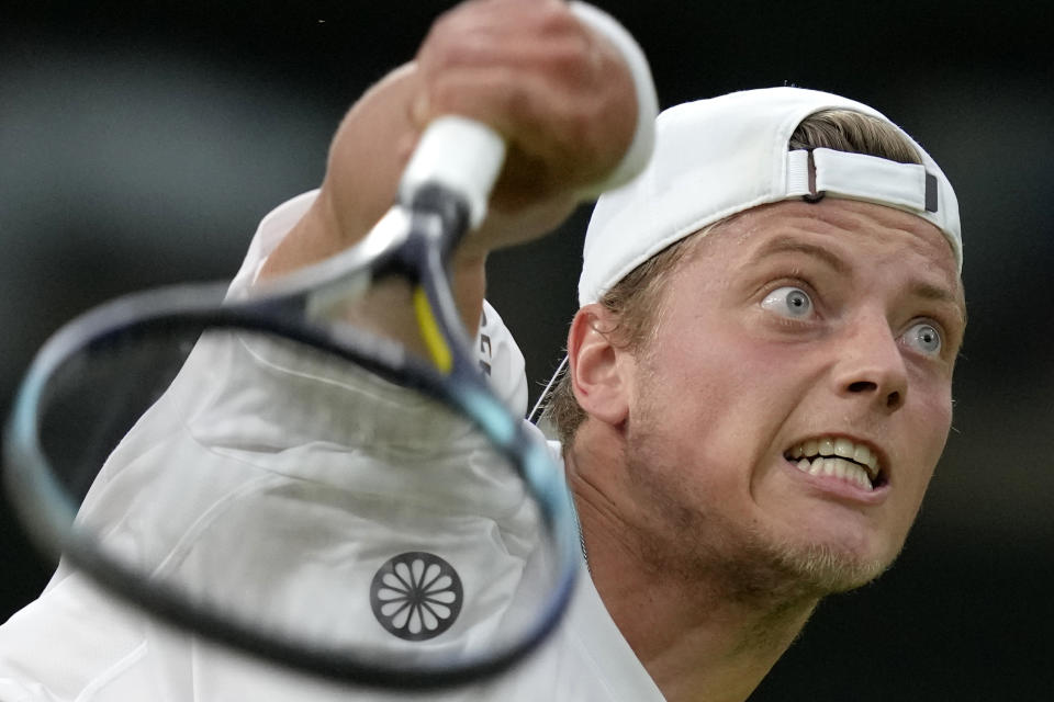 Tim van Rijthoven of the Netherlands serves to Serbia's Novak Djokovic during a men's fourth round singles match on day seven of the Wimbledon tennis championships in London, Sunday, July 3, 2022.(AP Photo/Kirsty Wigglesworth)