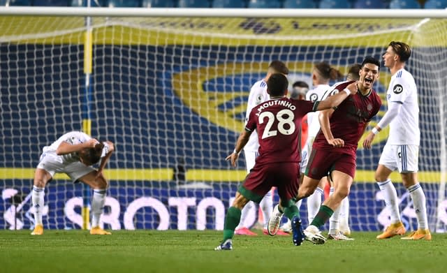 Raul Jimenez, right, celebrates after his shot was deflected in for the winner