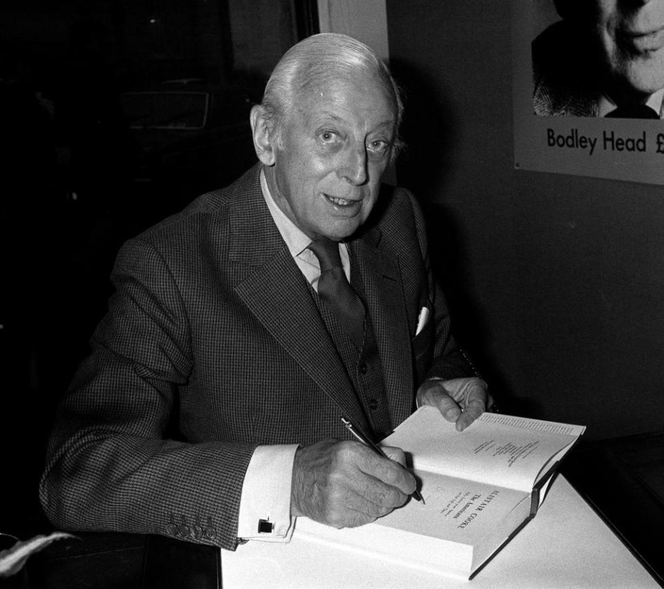 Cooke signs a book in 1979.