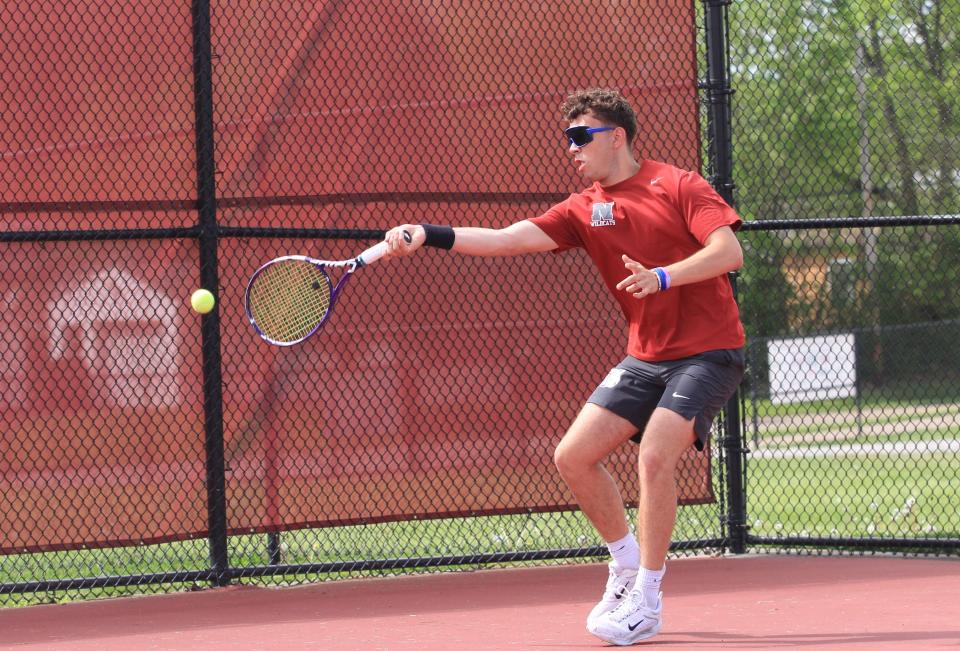 Newark's Will Woughter hits a return against Watkins Memorial on Tuesday.