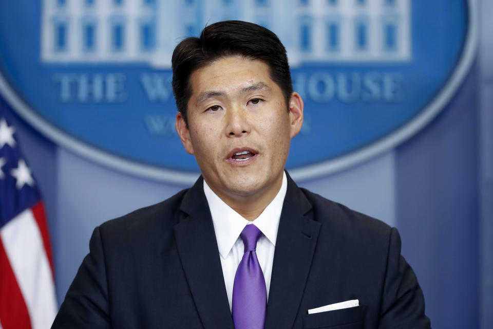 Robert Hur in front of White House seal and next to American flag.