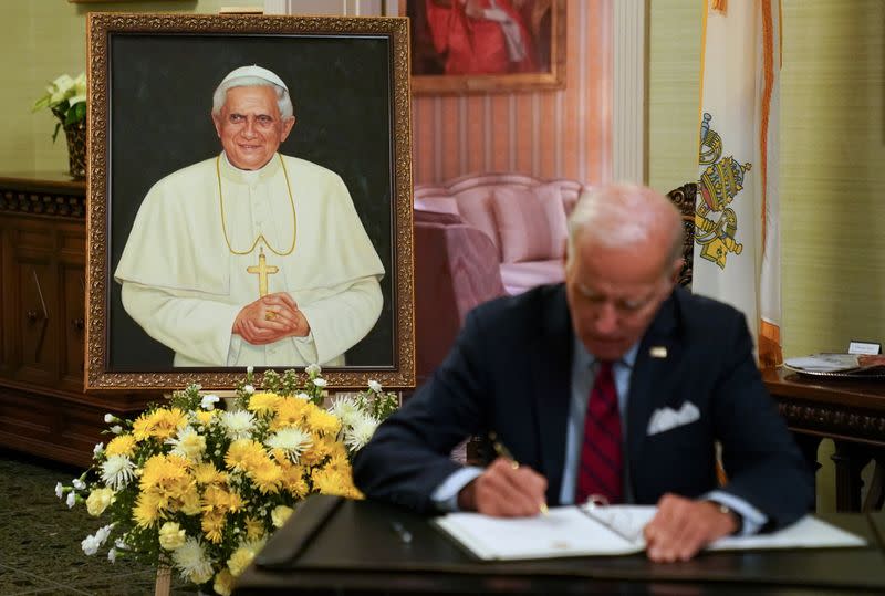 U.S. President Joe Biden signs a book of condolences for former Pope Benedict, in Washington