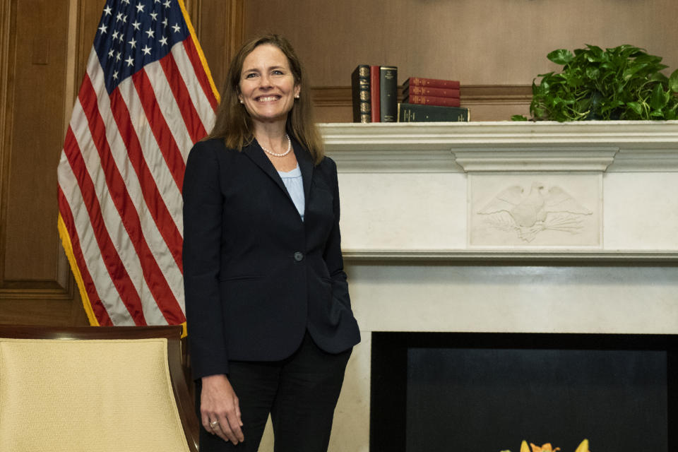 Supreme Court nominee Judge Amy Coney Barrett, smiles during a meeting with Sen. David Purdue, R-Ga., on Capitol Hill, Wednesday, Sept. 30, 2020, in Washington. (AP Photo/Manuel Balce Ceneta, POOL)