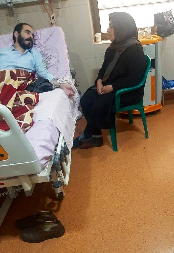 Iranian activist and blogger Hossein Ronaghi is treated in a hospital in Tehran, Iran, in this undated photo obtained by Reuters on November 14, 2022. Judiciary Media Center/WANA/Handout via REUTERS ATTENTION EDITORS - THIS IMAGE HAS BEEN SUPPLIED BY A THIRD PARTY.