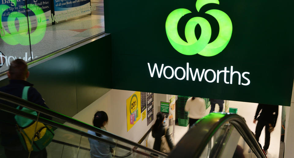 People entering an underground Woolworths store.