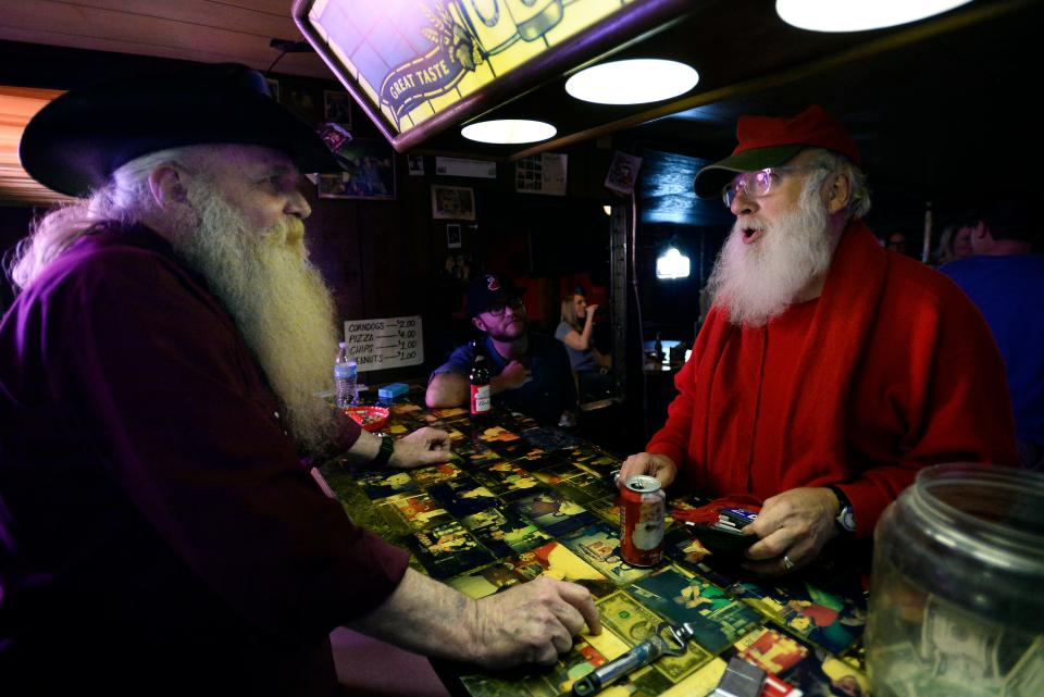 Elmer Denvel Irwin, left, talks with Bob Allen, who is known as East Nashville Santa, on Wednesday, Dec. 16, 2015 in Nashville, Tenn. Irwin, 66, owns Santa's Pub.
