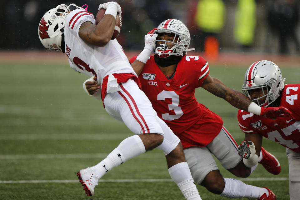 Ohio State defensive back Damon Arnette, right, tackles Wisconsin receiver Kendric Pryor during the first half of an NCAA college football game Saturday, Oct. 26, 2019, in Columbus, Ohio. (AP Photo/Jay LaPrete)