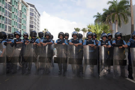 Police stand across Ashford Avenue in front of a hotel at which the Puerto Rico Chamber of Commerce will hold the first seminar of the Puerto Rico Oversight, Management and Economic Stability Act (PROMESA), in San Juan, August 31, 2016. REUTERS/Ana Martinez