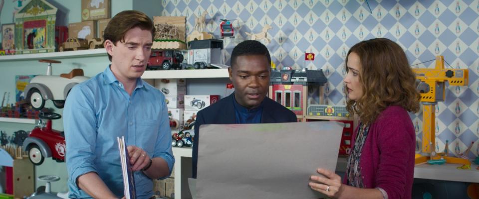 Two men and a woman in a toy store.