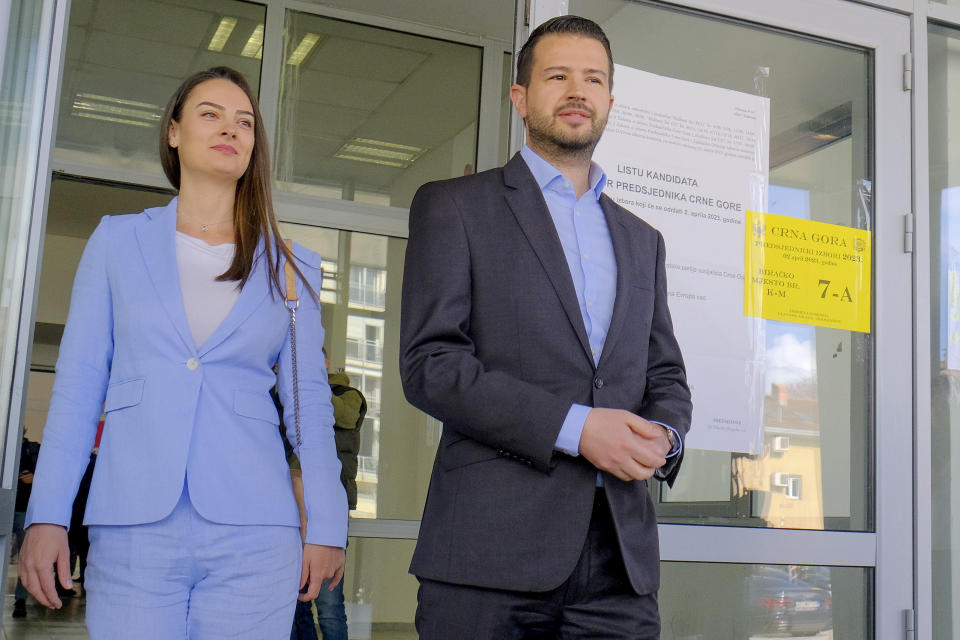 Candidate backed by governing parties advocating closer ties with Serbia Jakov Milatovic, right, and his wife Milena leave after voting at a polling station in Montenegro's capital Podgorica, Sunday, April 2, 2023. Montenegrins are casting ballots on Sunday in a runoff presidential election that is a battle between a long-serving pro-Western incumbent and a newcomer promising changes in the small NATO member state in Europe that has been locked in political turmoil. (AP Photo/Risto Bozovic)