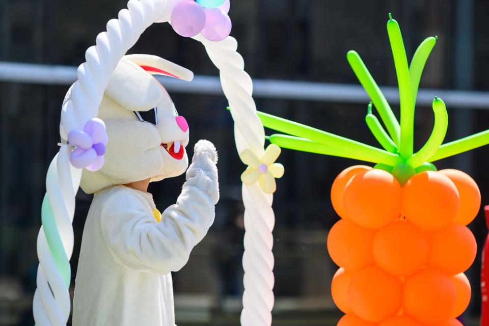 The Easter Bunny waves to visitors at Egg Stravaganza Saturday, March 27, 2021, in South Bend.