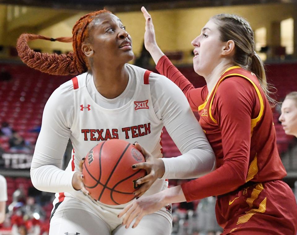 Texas Tech's center Jazmaine Lewis (42), left, looks to shoot the ball against Iowa State, Saturday, Dec. 31, 2022, at United Supermarkets Arena. 