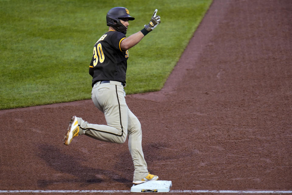 San Diego Padres' Eric Hosmer celebrates as he rounds first base after hitting a three-run home run off Pittsburgh Pirates starting pitcher JT Brubaker during the fourth inning of a baseball game in Pittsburgh, Saturday, April 30, 2022. (AP Photo/Gene J. Puskar)