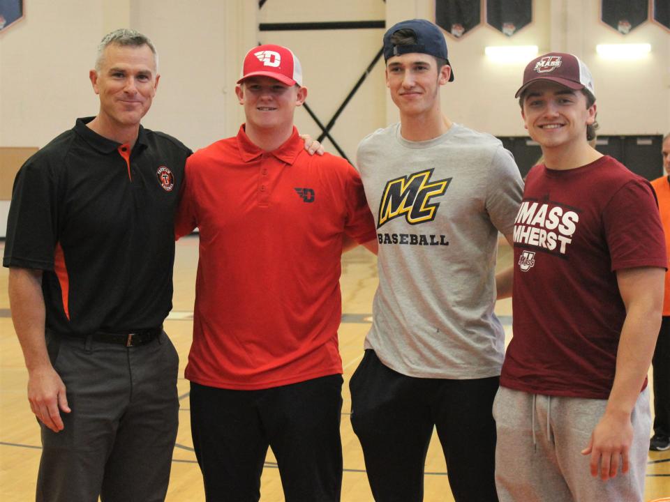 Taunton baseball coach Blair Bourque (left) poses with players Ryan MacDougall, Dawson Bryce and Braden Sullivan during an NLI signing ceremony on Nov. 14, 2022.