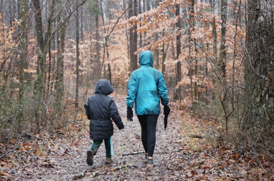 Walking through the woods on a rainy day are two participants in the 2022 First Day Trail Run at Fairfax State Recreation Area.