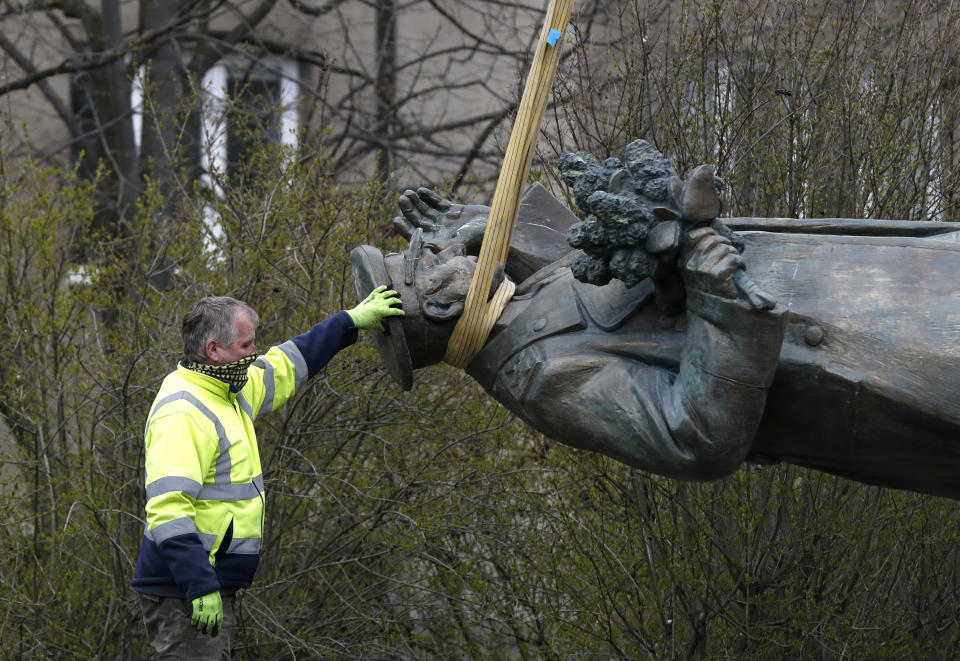 The statue of a Soviet World War II commander Marshall Ivan Stepanovic Konev is loaded onto a truck after its been removed from its site in Prague, Czech Republic, Friday, April 3, 2020. Marshall Konev led the Red Army forces that liberated Prague and large parts of Czechoslovakia from the Nazi occupation in 1945. His monument, unveiled in the Prague 6 district in 1980 when the country was occupied by Soviet troops, has been a source of controversy. (AP Photo/Petr David Josek)