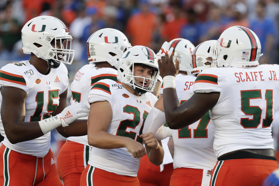 Miami place kicker Bubba Baxa (21) celebrates his 36-yard field goal against Florida with teammates, including quarterback Jarren Williams (15) and offensive lineman DJ Scaife Jr. (51), during the first half of an NCAA college football game Saturday, Aug. 24, 2019, in Orlando, Fla. (AP Photo/John Raoux)