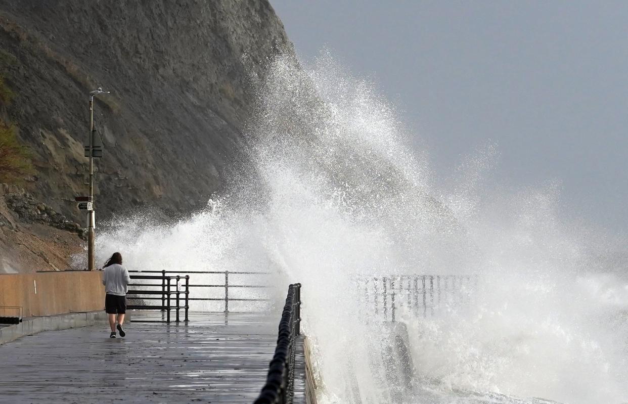 Waves crash over the promenade in Folkestone, Kent as Storm Debi hits the UK (Gareth Fuller/PA Wire)