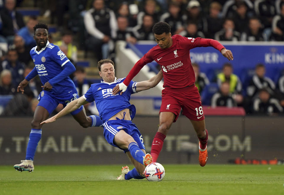 Leicester City's Jonny Evans tackles Liverpool's Cody Gakpo, right, in action during the English Premier League soccer match at the King Power Stadium, Leicester, England, Monday May 15, 2023. (Tim Goode/PA via AP)